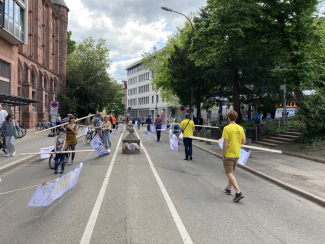 Menschen laufen mit Gehzeugen auf der Rempartstraße